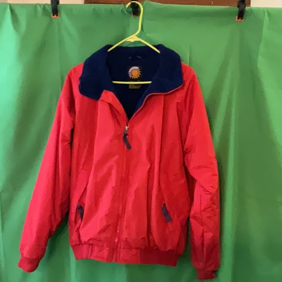 Bright red windbreaker with navy blue fleece lining and insulated sleeves. - Picture 4 of 11